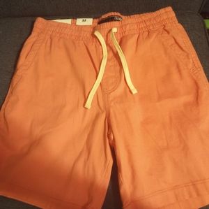 Plugg brand stretch pull on. Size M light pink